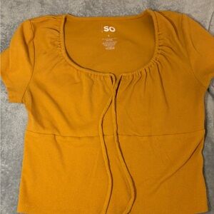 Yellow shirt with a tie in front of it